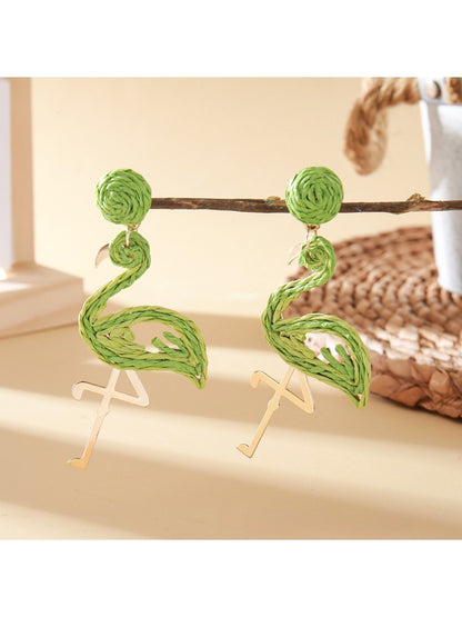 Detailed shot of the flamingo pendant earring showing pink enamel and metal details