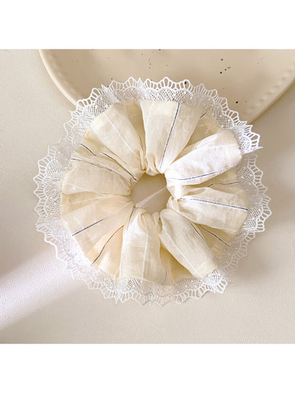 Gifty striped ruched scrunchie styled on a wrist as an accessory