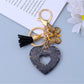 Silver heart pendant keychain displayed with soft lighting