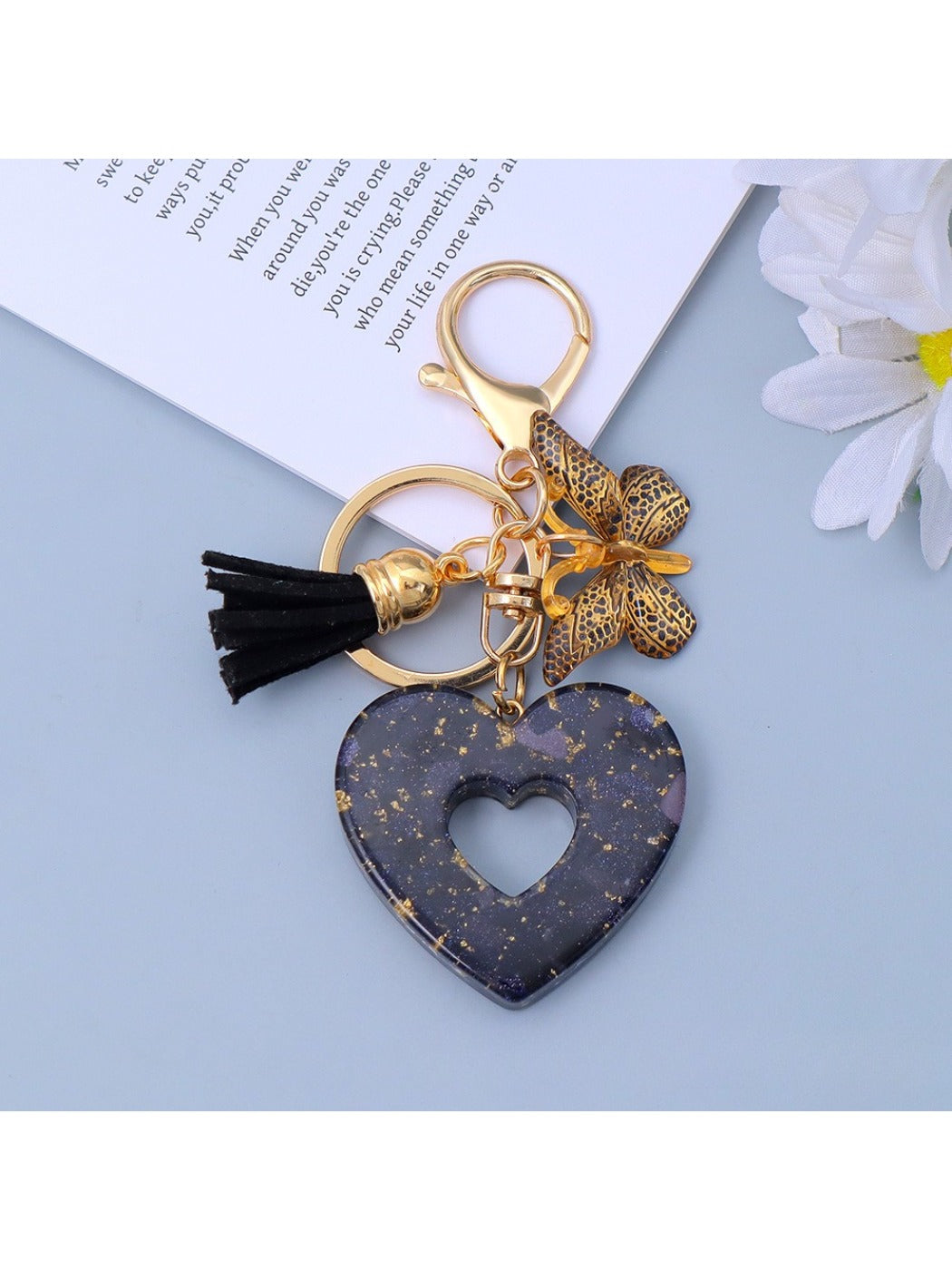 Silver heart pendant keychain displayed with soft lighting