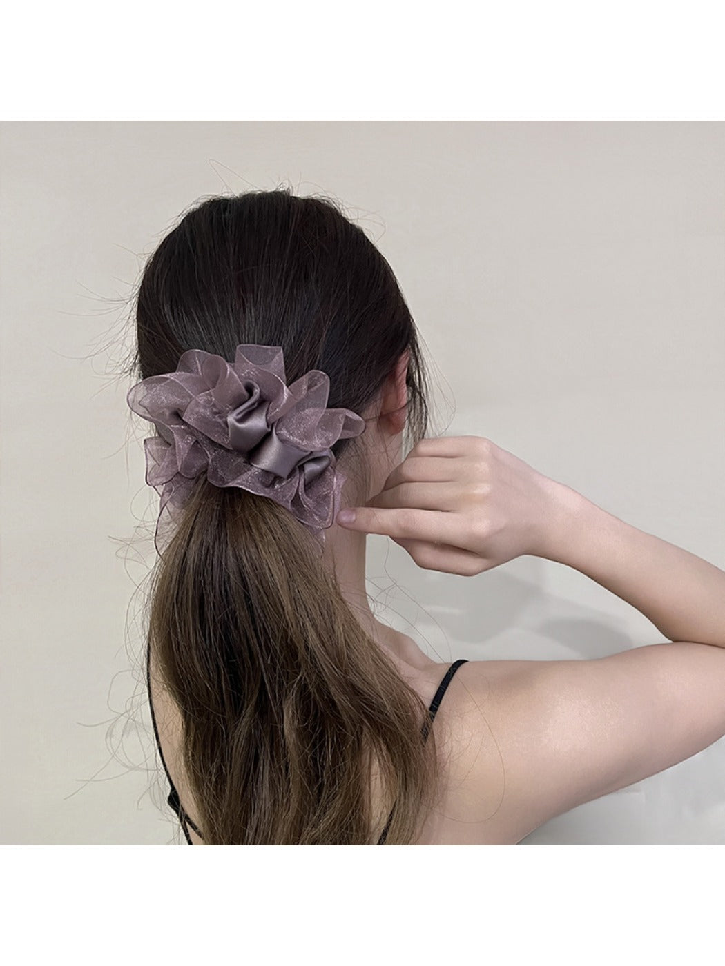 Close-up of ruffled edges on the solid color scrunchie showing fabric texture