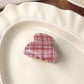Beau pink plaid crescent claw clip styled in a half-up hairdo