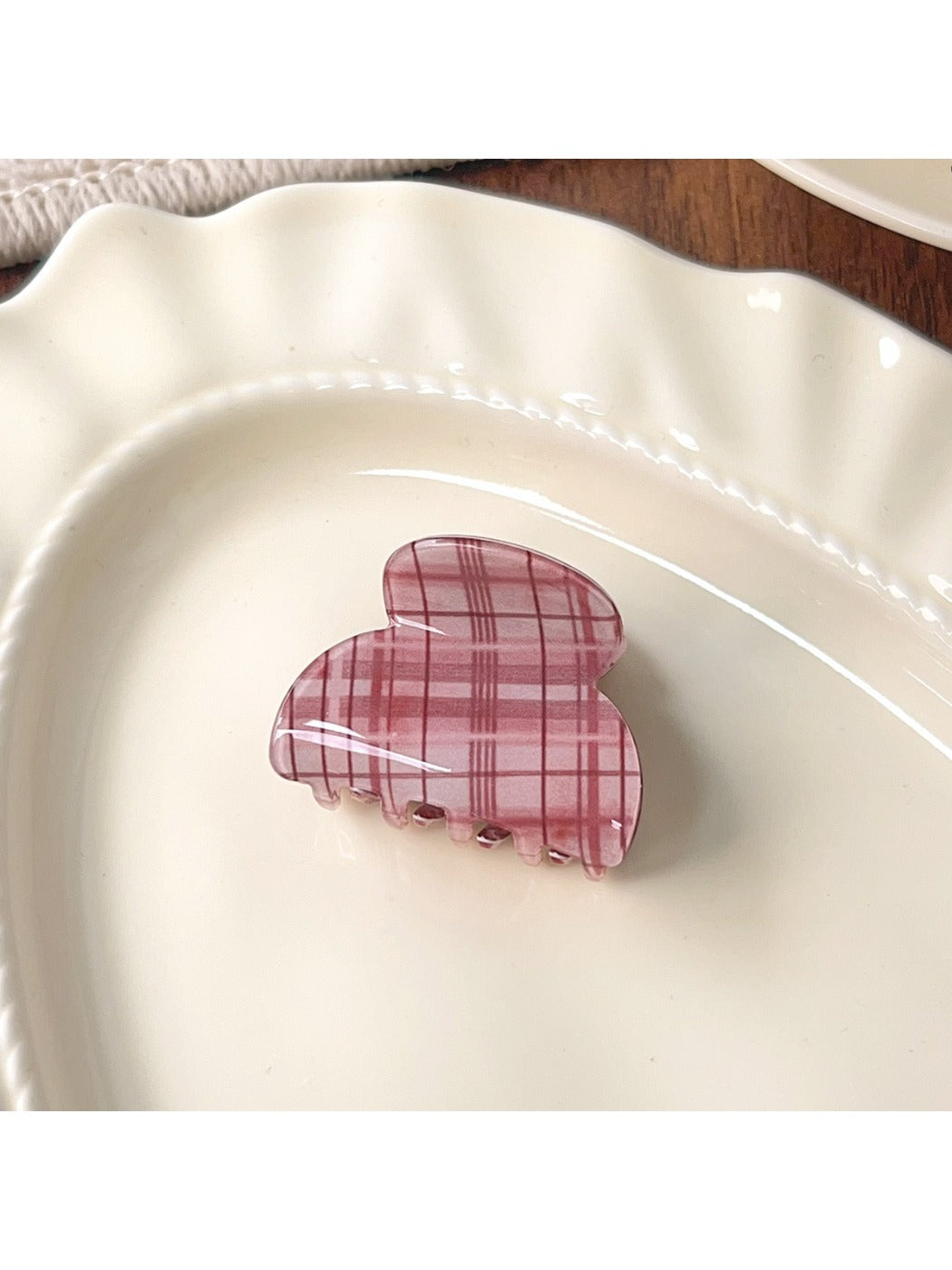 Beau pink plaid crescent claw clip styled in a half-up hairdo