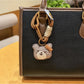 Group of bear charm keychains in different colors displayed on a white background