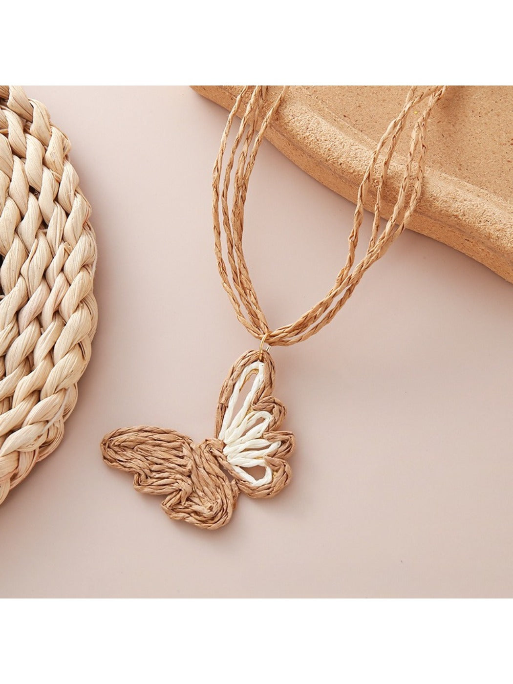 Side view of raffia butterfly pendant showing texture and shape