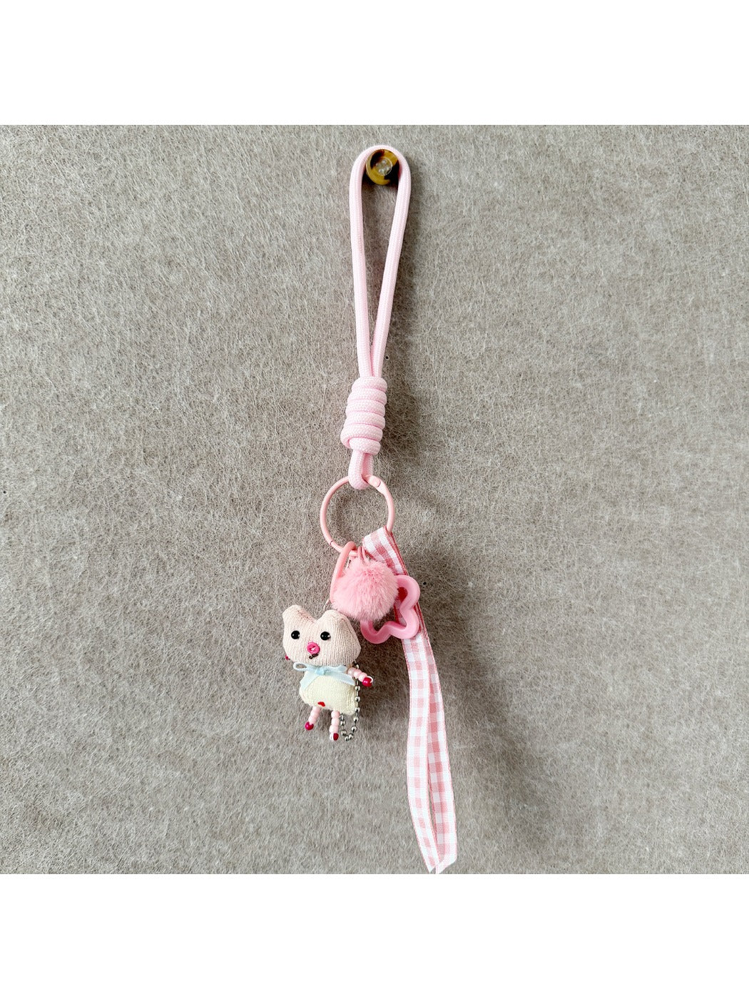 Fabric animal keychain attached to a set of keys on a wooden surface