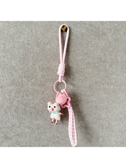 Fabric animal keychain attached to a set of keys on a wooden surface