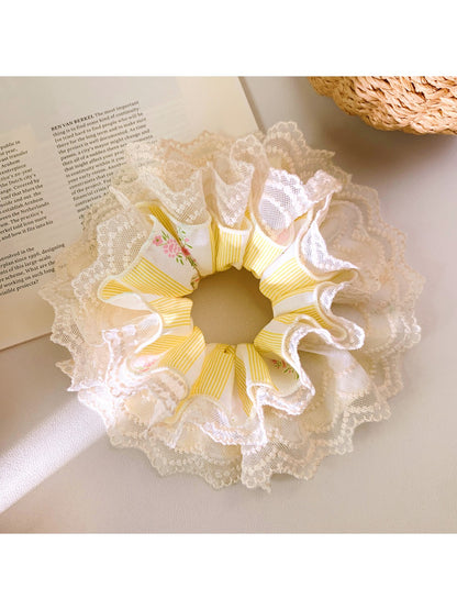 Yellow double layer lace scrunchie on a white background