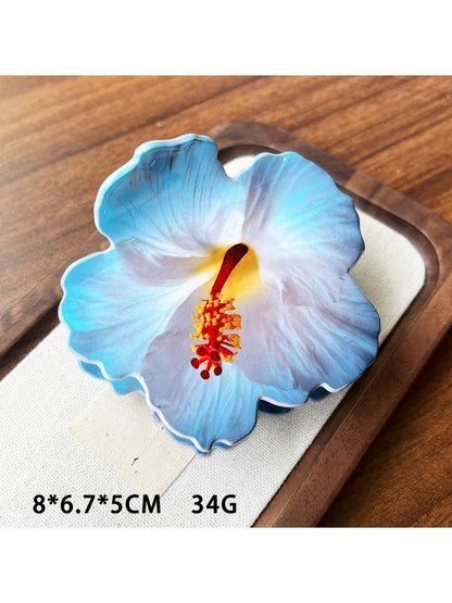 Beau hibiscus claw clip packaged in clear plastic box with branding