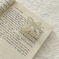 Beau acetate butterfly claw clip with light reflecting off glossy surface