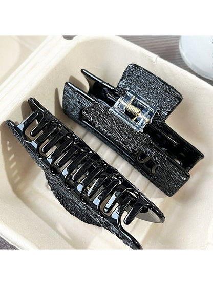 Side view of Beau black acetate claw clip highlighting curved teeth