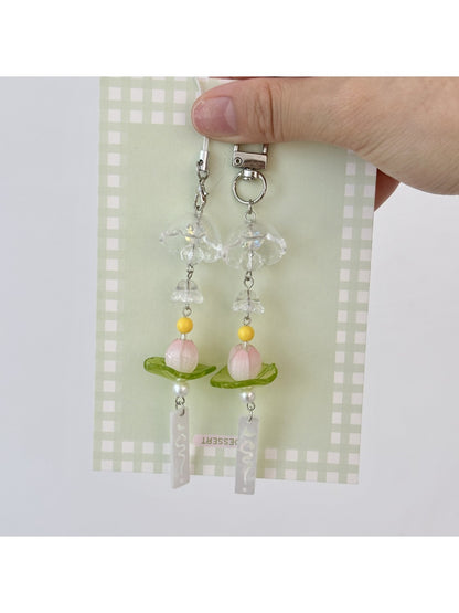 Close-up of lotus wind chime keychain showing detailed metalwork and hanging bells