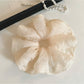 Minimalist scrunchie displayed flat showing its thin, solid color design