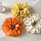 Gifty ruffle scrunchie displayed on a white background showing its texture