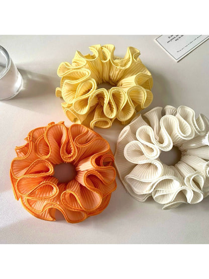 Gifty ruffle scrunchie displayed on a white background showing its texture