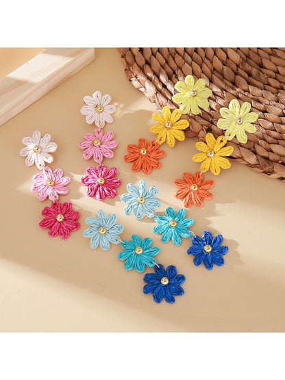 Close-up of colorful flower shaped drop earrings with multiple petals