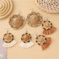 Close-up of Earedge straw hat shaped earrings on white background