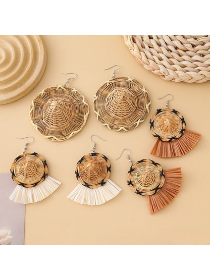 Close-up of Earedge straw hat shaped earrings on white background
