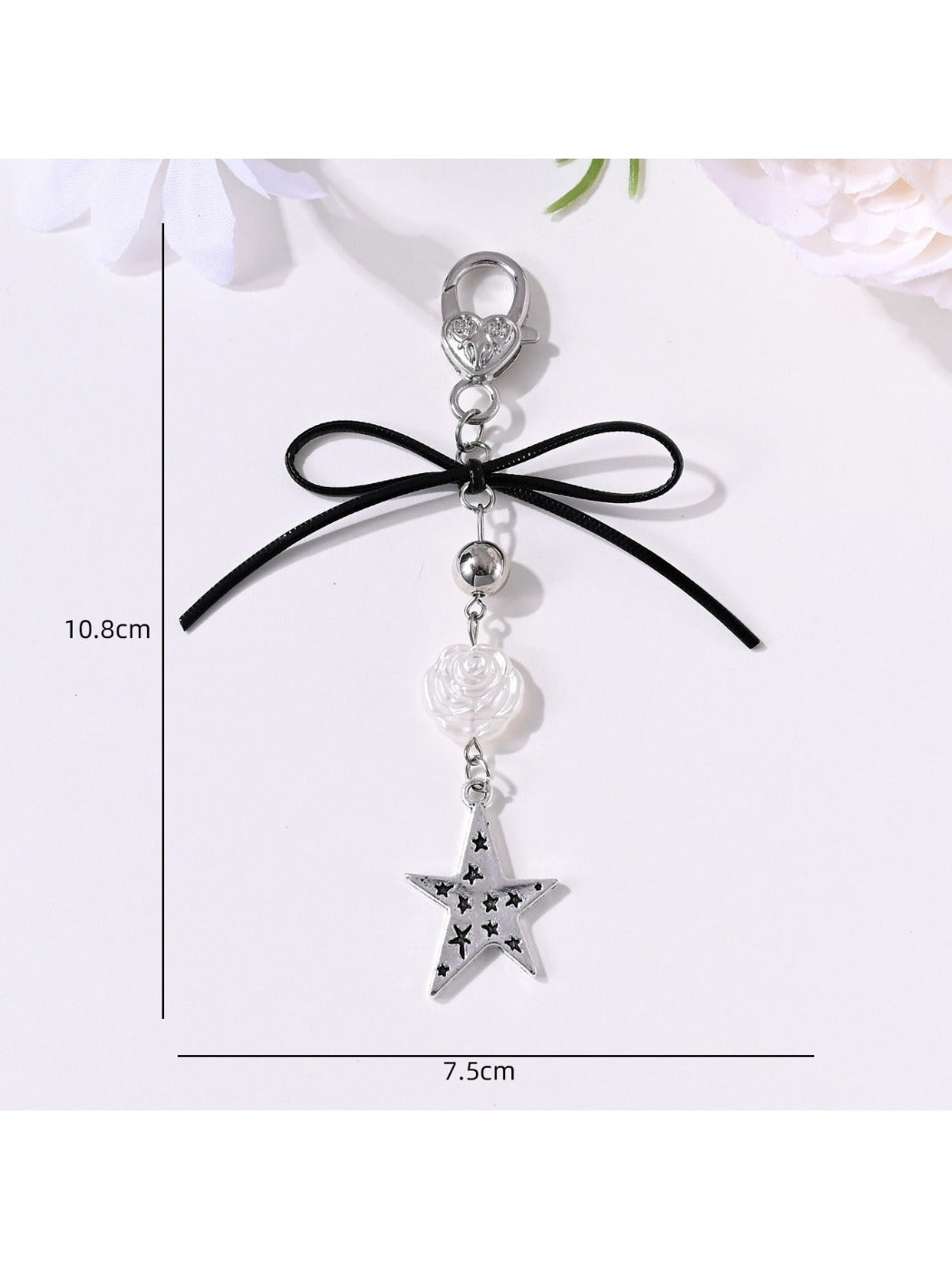 Keypus keychain displayed hanging with star and heart pendants visible