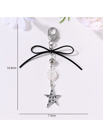 Keypus keychain displayed hanging with star and heart pendants visible