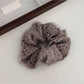 Gifty leopard print tulle scrunchie styled in a ponytail on brown hair