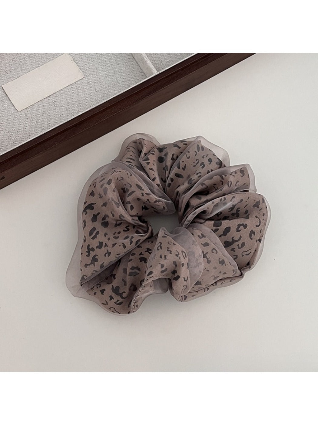 Gifty leopard print tulle scrunchie styled in a ponytail on brown hair