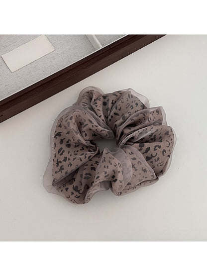 Gifty leopard print tulle scrunchie styled in a ponytail on brown hair