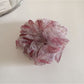Gifty floral print hair scrunchie packaged in clear plastic with branding visible