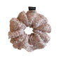 Pink floral print tulle scrunchie displayed flat with ruffled edges
