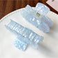 Beau claw clip open displaying spring hinge and gradient blue color