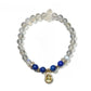 Lovra bracelet arranged with other jewelry pieces on a flat surface