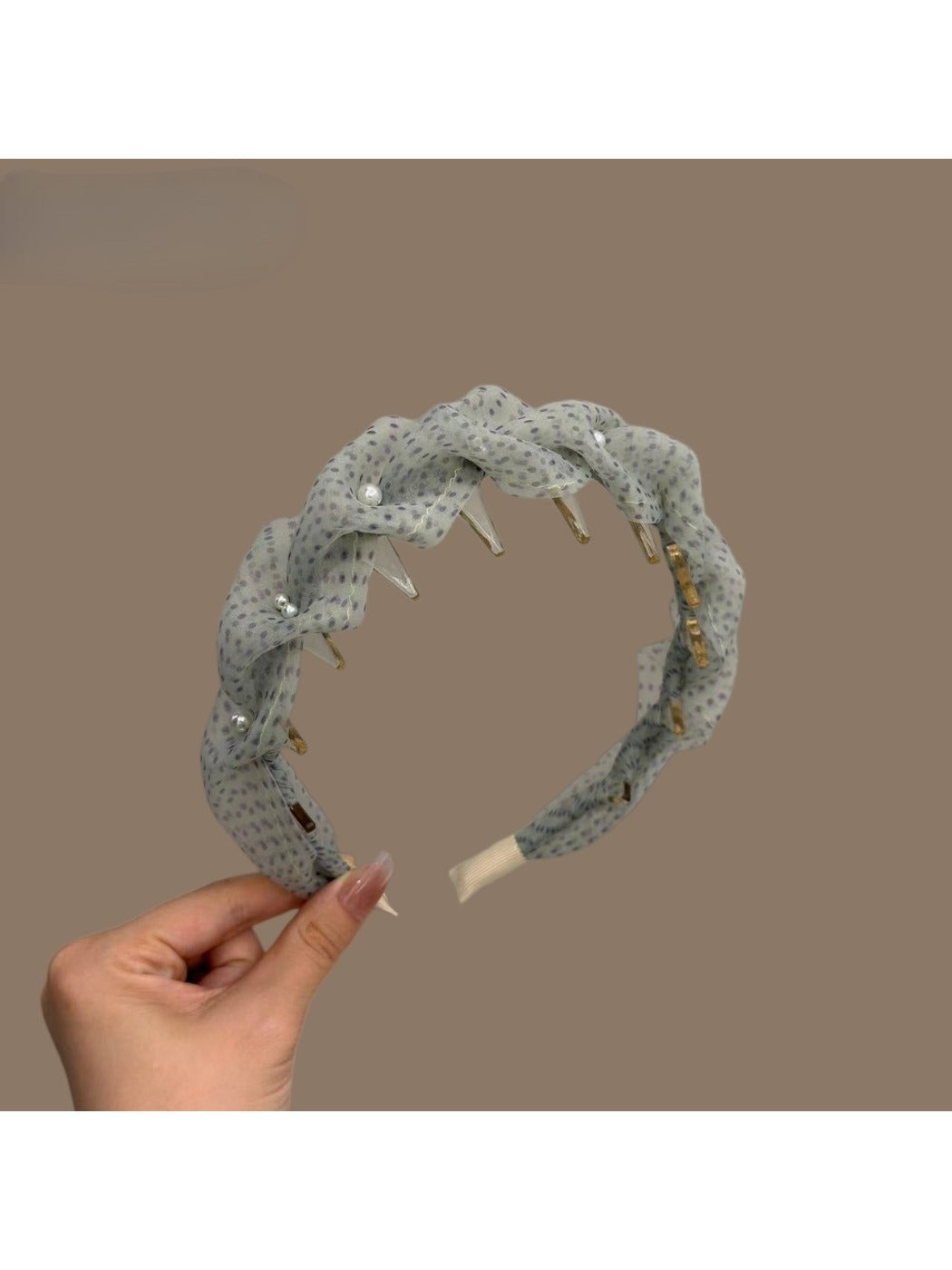 Green tulle headband with white polka dots styled on a mannequin