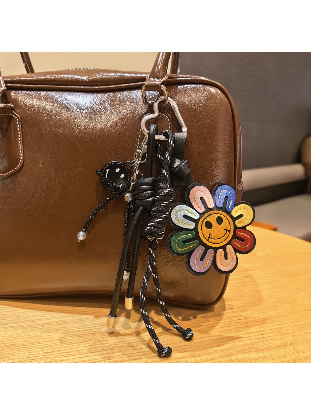 Close-up of rainbow sunflower keychain showing detailed petal texture and gold ring