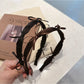 Side view of Gifty ribbon bow headband showing bow detail and band texture