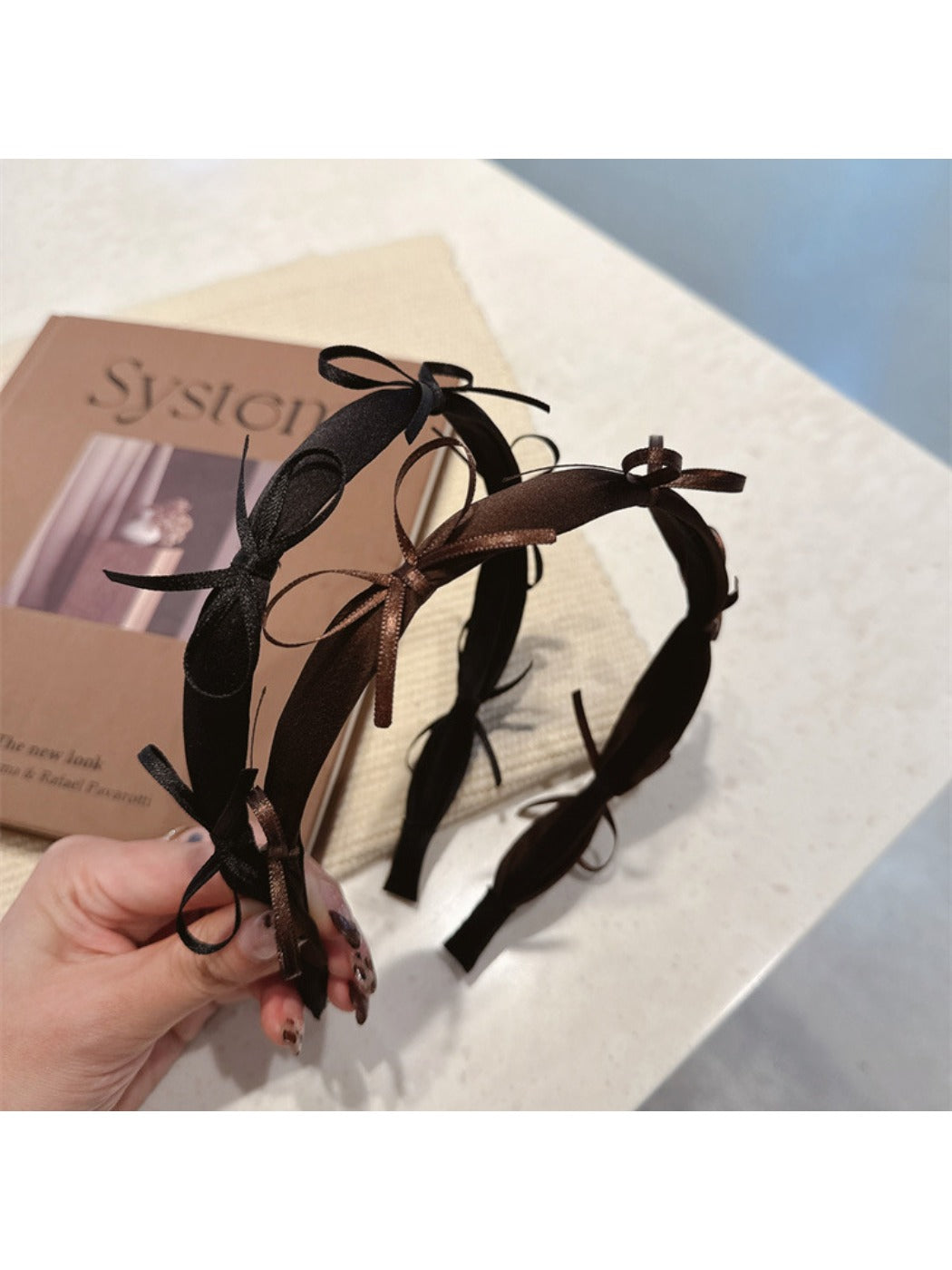 Side view of Gifty ribbon bow headband showing bow detail and band texture