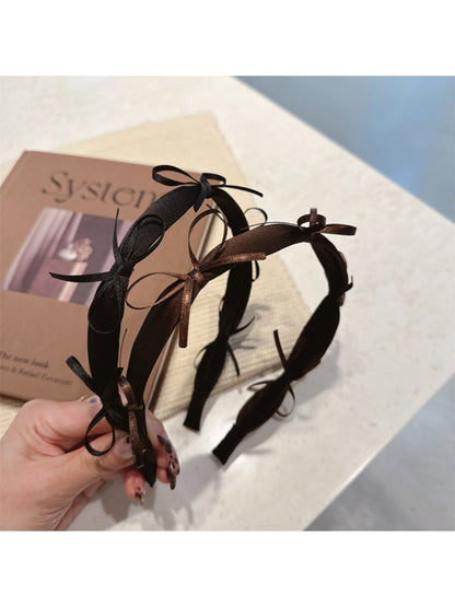 Side view of Gifty ribbon bow headband showing bow detail and band texture