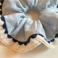 Side view of Gifty scrunchie highlighting gathered fabric and smooth texture