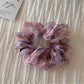 Scrunchie on wrist as a colorful floral accessory