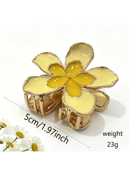 Beau flower hair clip with layered fabric petals and shiny gold center detail