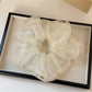Multiple Gifty minimalist scrunchies in different solid colors arranged side by side