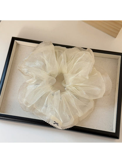 Multiple Gifty minimalist scrunchies in different solid colors arranged side by side