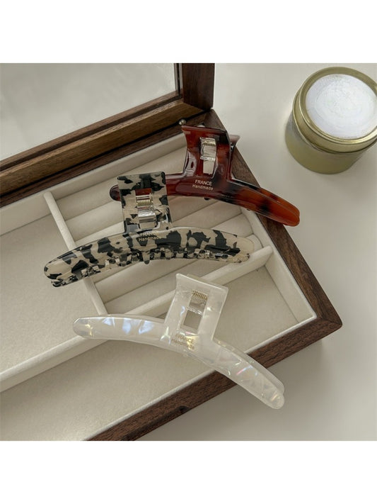 Beau elegant acetate claw clip in tortoiseshell pattern on white background