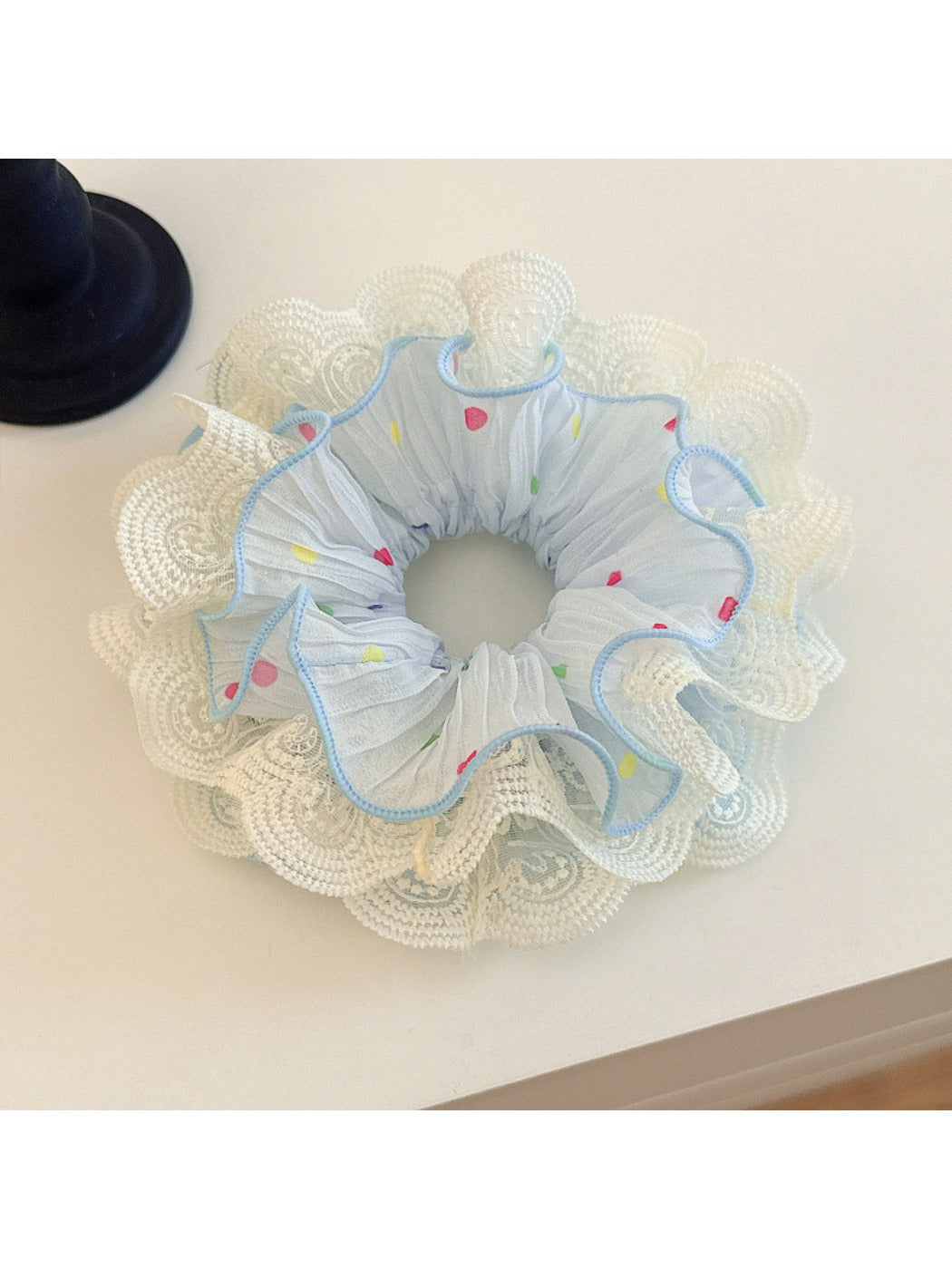 Gifty polka dot lace double layer scrunchie in black with white dots on a neutral background