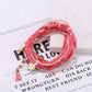 Lovra bracelet laid flat showing full length and heart pendant centerpiece