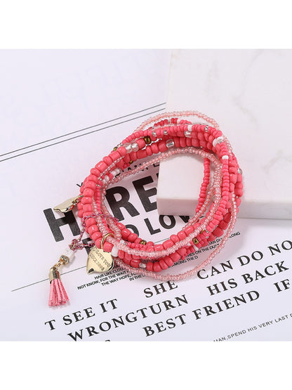 Lovra bracelet laid flat showing full length and heart pendant centerpiece
