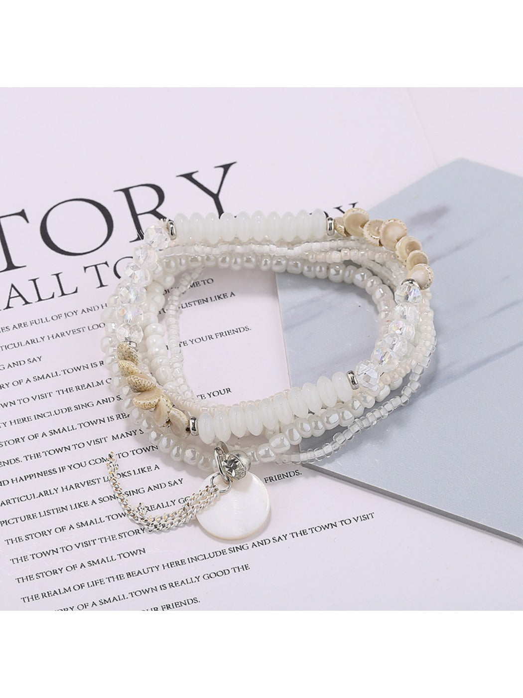Lovra bracelet displayed flat with multiple rows of bright beads and gold elements