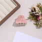 Beau hair clip with leopard print pattern placed on wooden surface