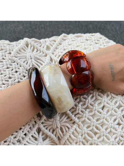 Lovra bracelet styled on wrist with layered jewelry and casual outfit
