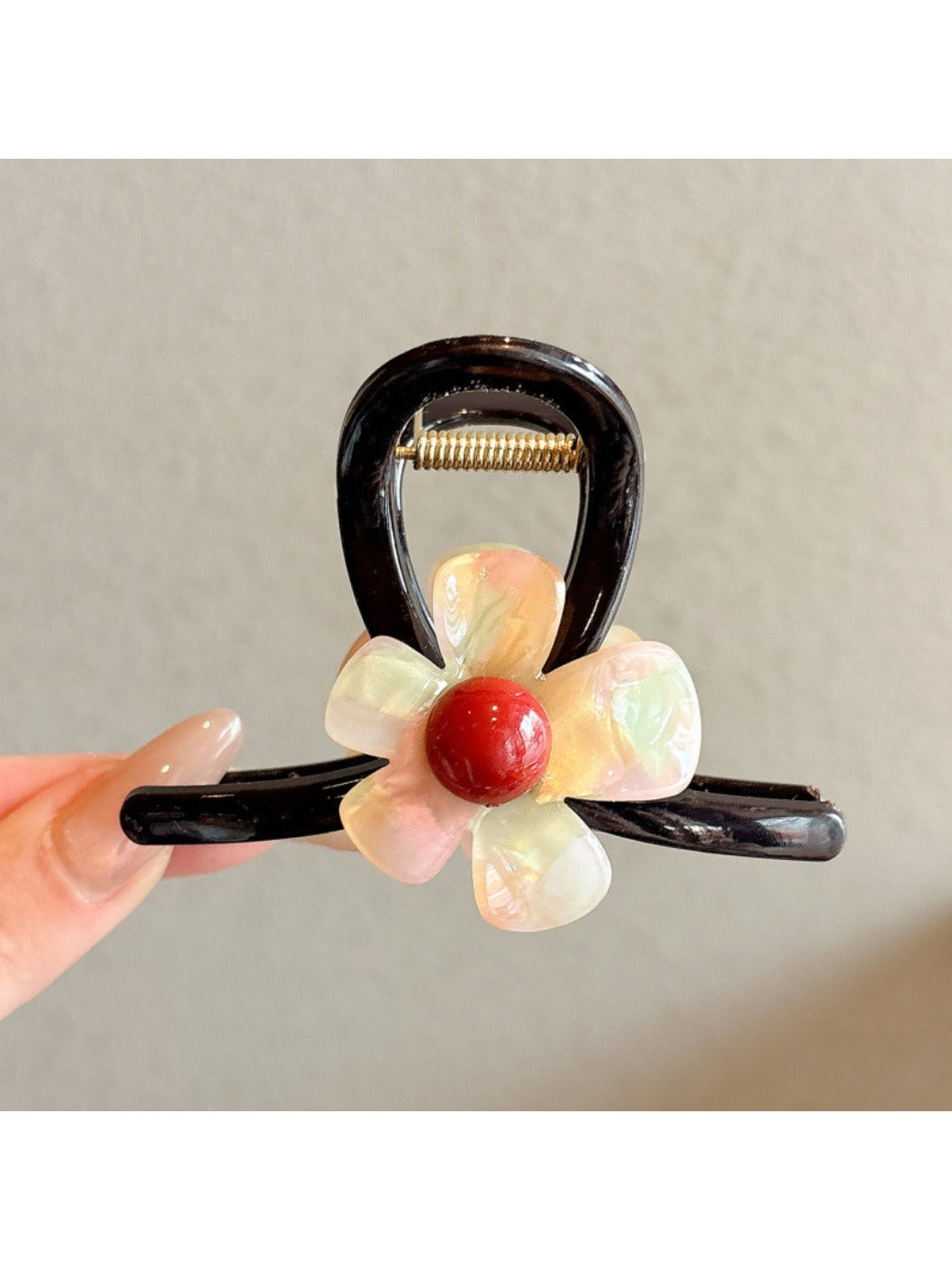 Beau pink flower claw clip styled in a woman's hair