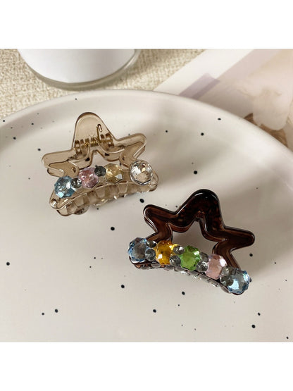 Beau star shaped claw clip open, displaying inner claw grips